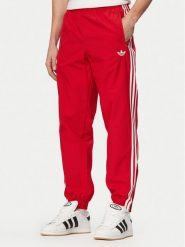 Adidas Spodnie dresowe Firebird Woven KE1369 Czerwony Regular Fit. Czerwone spodnie sportowe męskie Adidas, m, bez wzorów, z dresówki. Za 254.99 zł.